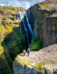 Exploring the majestic waterfalls of iceland with scenic cliffs and lush greens
