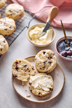 Classic scones with butter and cherry cherry jam on a plate