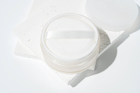 Loose powder in elegant white cosmetic container