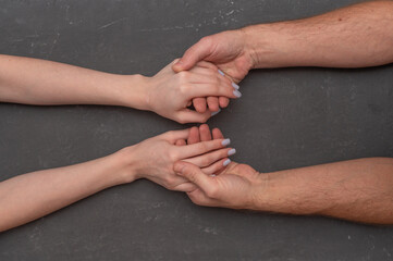 Two hands connected in gentle gesture reflecting trust, empathy, and human connection. Close-up of...
