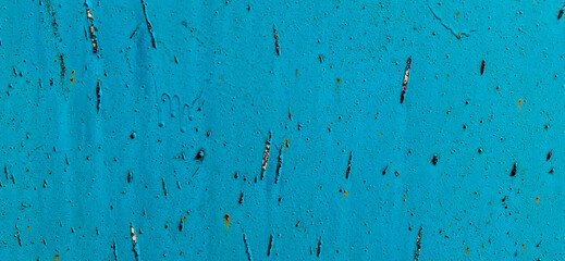 Metal painted with blue paint. Scratched paint, rusting metal.