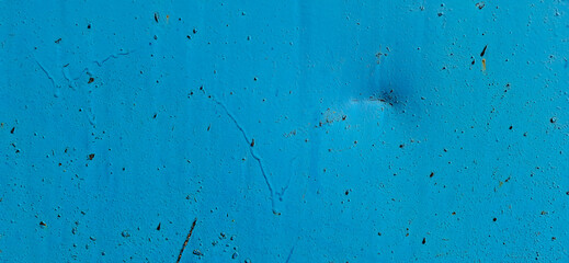 Metal painted with blue paint. Scratched paint, rusting metal.
