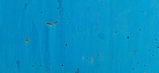 Metal painted with blue paint. Scratched paint, rusting metal.