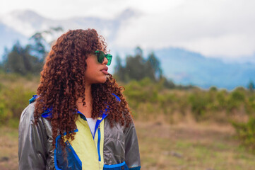 Young hiker contemplating mountain view in overcast weather