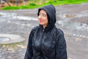 Tourist wearing raincoat exploring nature reserve