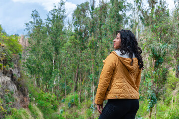Tourist enjoying the view of a green forest during a cloudy day