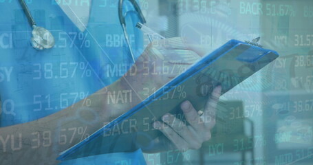 Writing on clipboard scrub-clad doctor in hospital corridor, with stethoscope and finance overlay