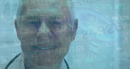 Standing senior doctor wearing lab coat and stethoscope in CT gantry room, with holographic data