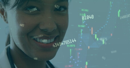 Smiling female doctor wearing white coat and stethoscope viewing charts in clinic, copy space