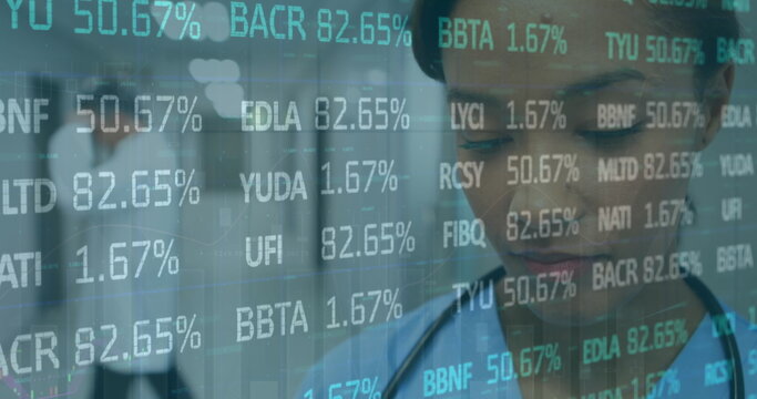 Walking blue-scrub nurse in hospital corridor, with ticker symbols overlay, stethoscope, copy space