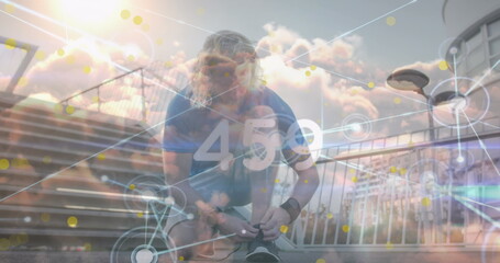 Tying running shoelaces man kneeling in blue athletic shirt on urban walkway, with data overlay