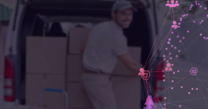 Unloading uniformed delivery worker lifting cardboard box at van rear, with digital network overlay - Powered by Adobe