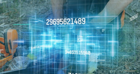 Fototapeta premium Kneeling forest worker wearing orange vest using hologram in woodland clearing, with chainsaw