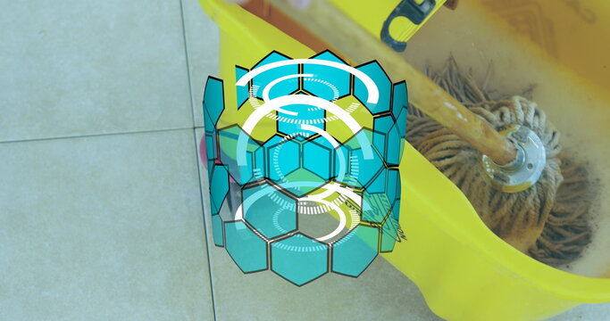 Fototapeta Wringing wood-handle mop with yellow wringer bucket on tiles featuring hexagon overlay, copy space