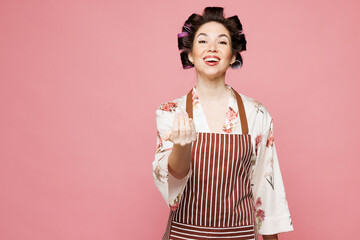 Young happy housewife housekeeper chef cook baker woman wear brown apron do hand gesture pov call...