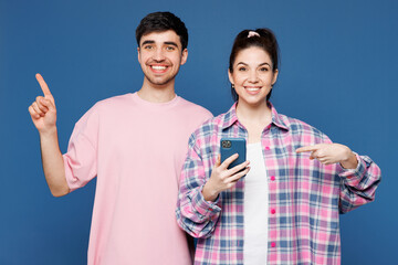 Young couple two friends family man woman wear pink casual clothes together hold in hand use mobile...