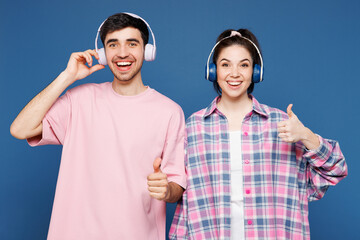 Young happy couple two friends family man woman they wear pink casual clothes together listen to...