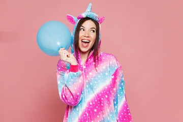 Young happy woman she wear domestic costume with hoody and animal ears blow up blue balloon look...