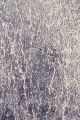 Concrete texture. Pebbles of different colors and signs of aging are visible.
