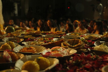 Food in plates with people in background