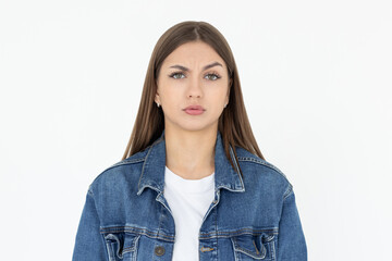 Hmm. Let me think. Studio shot of cute girl looking at camera with thoughtful and sly expression, raising one brow as if having good idea, planning something