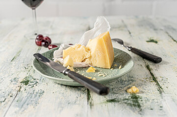 Italian Grana Padano cheese on the plate in shabby look