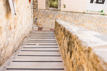 Stone staircase leading to old town street. Urban navigation, architectural texture, and...
