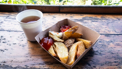 french fries served in a paper box and a cup