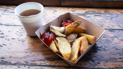 french fries served in a paper box and a cup
