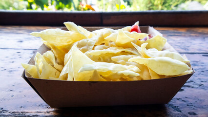 Crispy snack with chili sauce served in a paper box