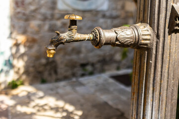Close-up of ornate bronze water tap. Vintage craftsmanship, historical design, and functional...