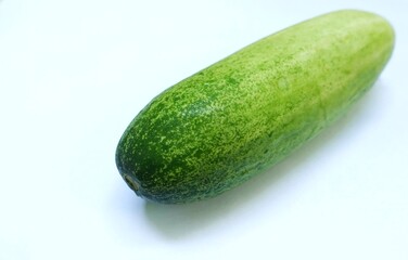 A fresh and clean cucumber isolated on a bright background.