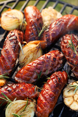 Grilled pork sausages on a cast iron grill, close-up view