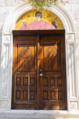 Wooden church door with religious mosaic, Montenegro, Budva. Orthodox symbolism, sacred...