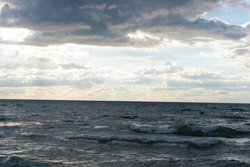 Distant skyline of Chicago over Lake Michigan under dramatic clouds