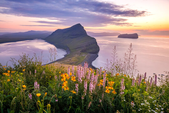 Serene sunset over dramatic cliffs and coastal bay in the faroe islands