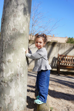 Little girl explores nature with joy in the park