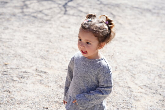 Little girl enjoys a sunny day at the park