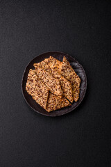 Crispbread, thin bread with seeds and grains, a baked cracker. Crispbread with sesame seeds