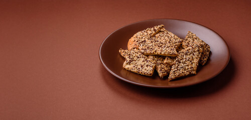Crispbread, thin bread with seeds and grains, a baked cracker. Crispbread with sesame seeds