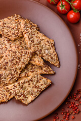 Crispbread, thin bread with seeds and grains, a baked cracker. Crispbread with sesame seeds