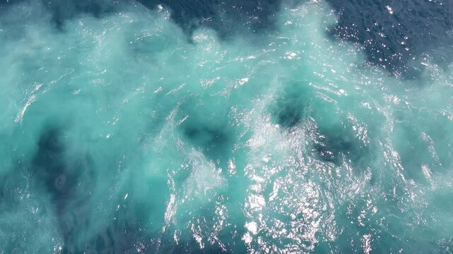 Pearl-green water boils overboard after passing a large ship. Bali Sea-Flores Sea