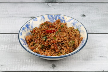 Traditional Turkish bulgur salad Kisir close-up on a plate on the table. Horizontal view from above