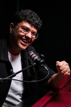 Podcast host recording live with microphone setup