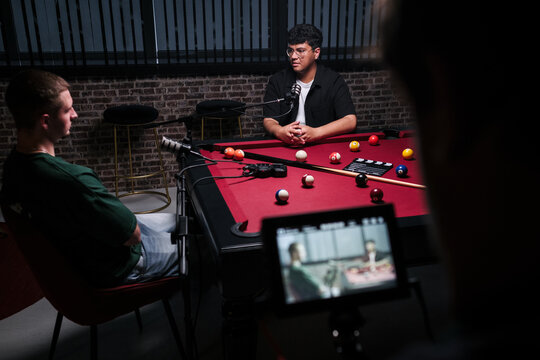 Podcast recording with live discussion on pool table