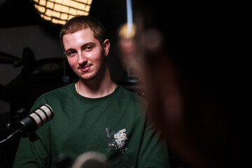 Podcast host at recording session discussing live topics