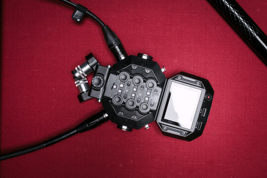 Professional podcast recording equipment on red background