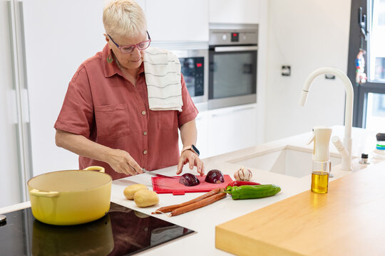 Elderly woman enjoying peaceful moments in her kitchen