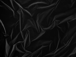 Reflective Fluorescent crumpled dark black cloth. Shiny folded material. Abstract monochrome...