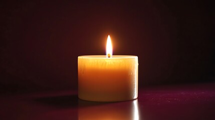 Burning candle glowing in the dark background